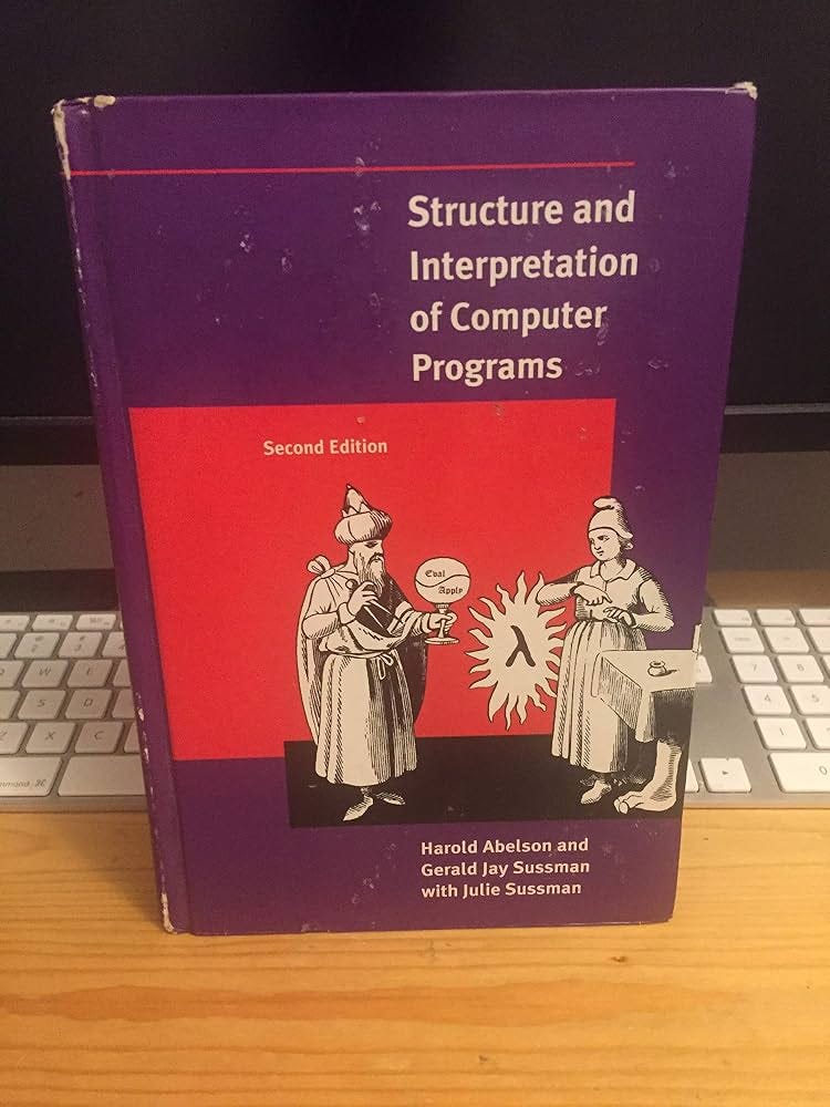 A copy of Structure and Interpretation of Computer Programs on a desk.