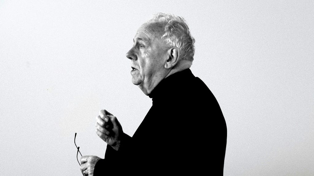 Alasdair MacIntyre speaking in profile.